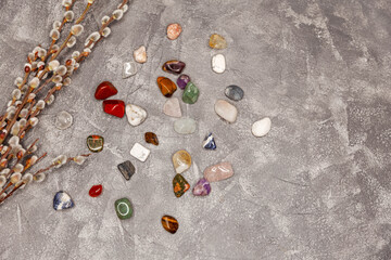 Spiritual practice, esoteric. Magic rock for crystal ritual, witchcraft, relaxing chakra, healing stones. Gemstones crystal minerals for meditation. Multiple semi precious gemstones on grey board.