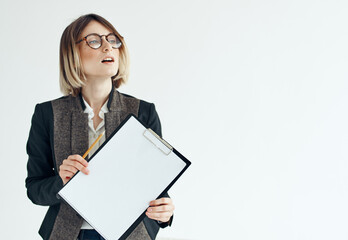 Business woman in a jacket manager model glasses and a white sheet of paper