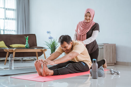 happy muslim Asian fitness couple, man and woman exercising together at home