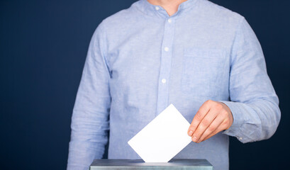 Voter Putting Ballot Into Voting box.