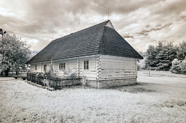 Old wooden hut. Infrared photo.