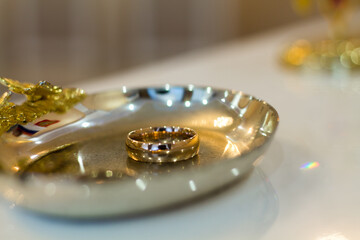 gold rings on a yellow stand. Rings for the bride and groom.