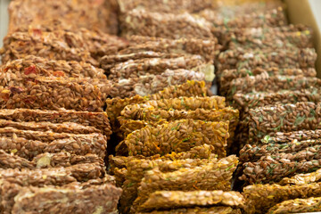 Vegan crackers breadcrisp made with sesame, flax, sunflower, pumpkin and hemp seeds. Raw food background.