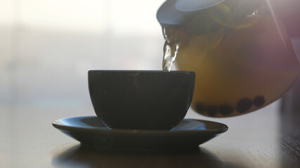 Pouring fruit tea in mugs at a cafe. 4k