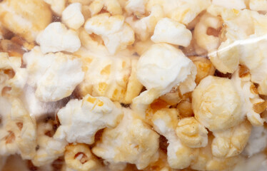 Popcorn in a plastic bag as a background.