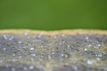 Closeup view of very small hailstones on frozen water in a garden vase, Dublin, Ireland. Soft and selective focus. Irish winter weather