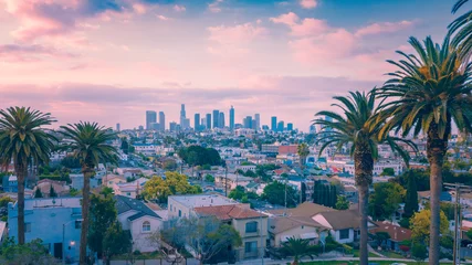 Foto op Canvas Beautiful sunset of Los Angeles downtown skyline and palm trees © maramas