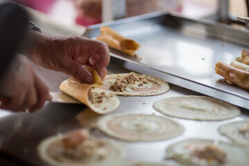 cooking rolling pancake (Khanom Tokyo) thin flat pancake filled with sweet custard cream - Thai street snack