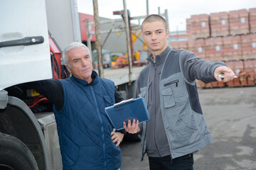 trucks driver with tradesman in factory stock