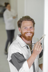 happy painter man working on a wall