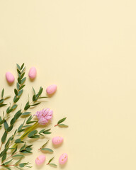 Pink eggs, hyacinth and eucalyptus on yellow background