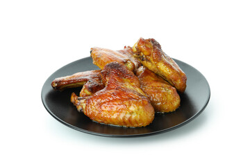 Plate with baked chicken wings isolated on white background