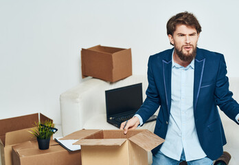 Business man in office suit boxes with things moving laptop technology official packing