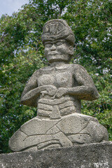 Fototapeta na wymiar Beautiful stone carving of male warrior on village megalithic tomb in Pau Rende, Sumba island, East Nusa Tenggara, Indonesia