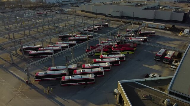 TTC public transit buses at large operations, maintenance and storage facility revealing empty parking spaces; aerial