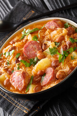 Sauerkraut and Bean Stew Slovenian Jota closeup in the plate on the table. Vertical