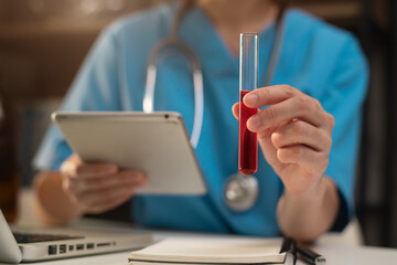 Lab work, Doctor holds a test tube takes the test from a test tube in analysis, blood, DNA, test tube stand. © NINENII
