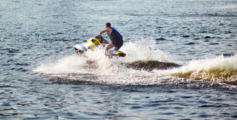 Man speeding on jet ski on lake during summer vacation