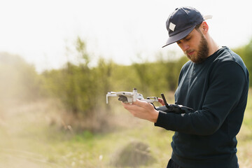 Guy launches a drone in field