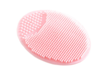 Pink silicone cosmetic facial brush on a white background, isolate. Skin care, macro