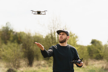 Guy launches a drone in field