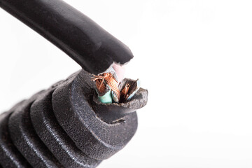 Broken electrical wire with a plug on a white background, isolate, close-up. Electric shock