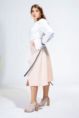 Young white woman isolated on light grey