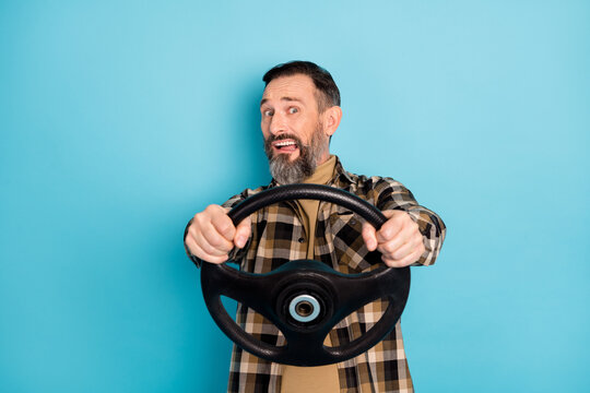 Photo portrait of nervous worried man driving car trying to get license isolated on vibrant blue color background