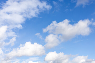 Detail of a white cloud in a bright blue sky. 
Dark rain clouds displace the blue sky. Storm is...