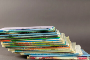 Stack of old school exercise books on a gray background.