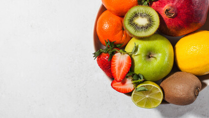 Flatlay assorted fresh and ripe fruits and berries. The concept of healthy eating. Copy space.