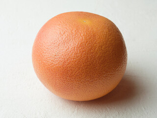 Whole grapefruit isolated on white background.