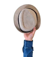 Man's arm raised holding a brown hat. Travel concept. Isolate on white background.