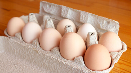 fresh chicken eggs in a cardboard box tray. Eco-friendly egg production. Baking ingredients. Organic chicken eggs - fresh from the manufacturer.