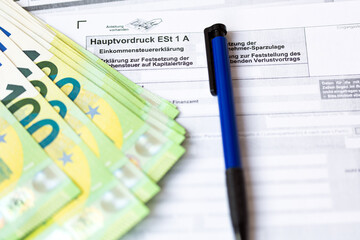 German tax form Hauptvordruck ESt 1 A with pen and euro bills
