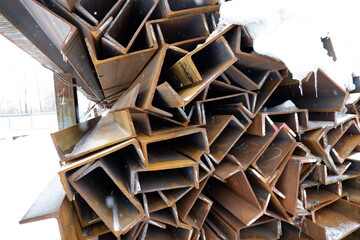 rolled metal lies on the street under the snow