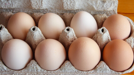 fresh chicken eggs in a cardboard box tray. Eco-friendly egg production. Baking ingredients. Organic chicken eggs - fresh from the manufacturer.