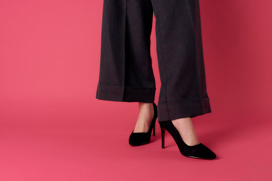Womens elegant legs black shoes fashion pink background