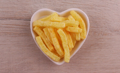 Chips in a white heart-shaped plate