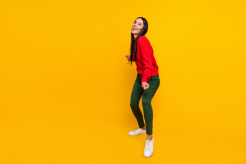 Fototapeta na wymiar Full size photo of young happy positive smiling cheerful woman dancing relaxing isolated on yellow color background
