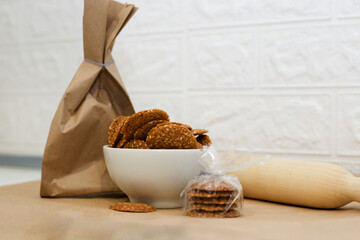 Small shortbread cookies with sesame seeds are beautifully packed in cellophane wrap.