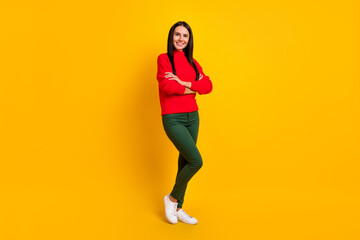 Fototapeta na wymiar Full size photo of young beautiful smiling woman with folded hands wear red sweater isolated on yellow color background