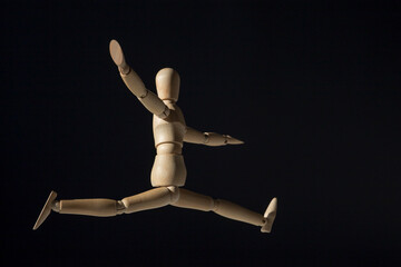 Wooden mannequin happy jump. Creative happiness concept.