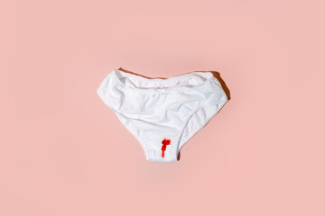 White cotton panties for women with traces of fresh red blood. Concept of menstruation, female...