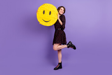 Full length body size view of attractive cheerful girl holding hugging yellow smiley posing...