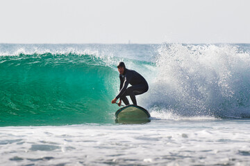 Surf Sup, Stand Up Paddle Boarding on a wave in Japan, a man is riding in the Pacific Ocean in...