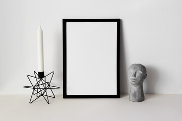Black frame mockup with candle on white background