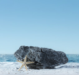 Background for cosmetic products on beach with sand. Natural rock stone podium and starfish. Empty...