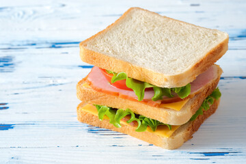Big tasty sandwich on rustic wooden background