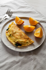 Homemade Bacon Spinach Omelette with Cheddar, low angle view.